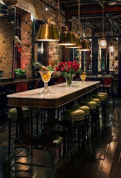 a long table with chairs and lights hanging from it