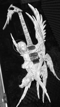 a sculpture of an angel holding a guitar