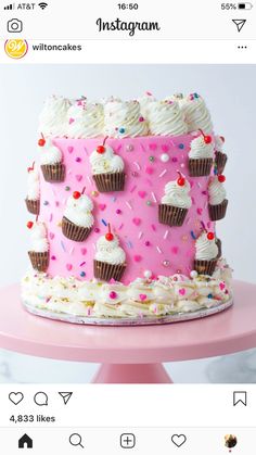 a pink cake with white frosting and sprinkles