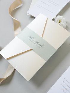 the wedding stationery is laid out on top of each other