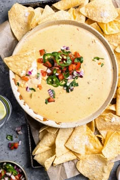 tortilla dip in a bowl surrounded by chips and salsa