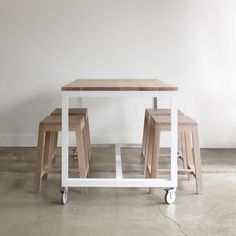 three stools sitting on top of a wooden table