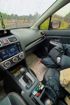 the interior of a car with many items in it