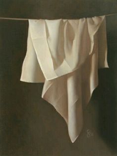 a white cloth hanging from a clothes line on a brown background, with the fabric pulled back