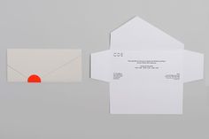 two envelopes, one with an orange circle on the front and one with a red circle on the back