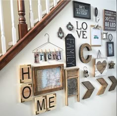 the wall is filled with wooden letters and magnets that spell out home, love, and other things