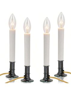 three white candles sitting on top of each other with one light turned on and the other turned off