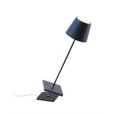 a lamp that is sitting on top of a table next to a light bulb with a black shade