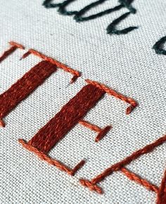 an embroidered piece of cloth with the words stitch on it