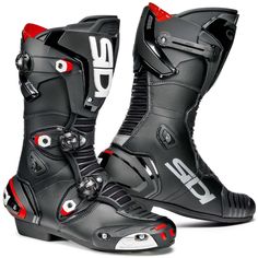 a pair of black and red motorbike boots with white letters on the soles