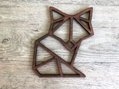 a wooden cutout of a fox on a wood background