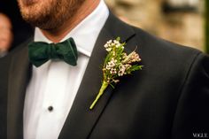 a man in a tuxedo with a boutonniere on his lapel