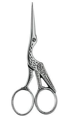 a pair of scissors with an intricate design on the front and back ends, in silver