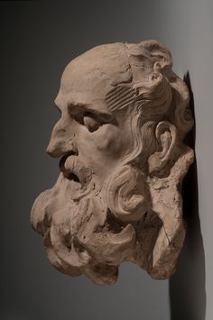 a sculpture of an old man's head is shown next to a statue of a bearded man