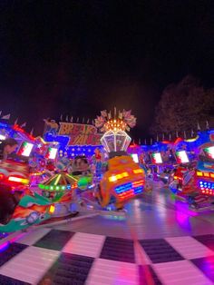 brightly lit carnival rides at night time