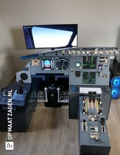 an airplane cockpit with multiple instruments and monitors on the wall, including a monitor screen