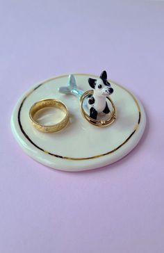 two rings and a ring holder on a plate