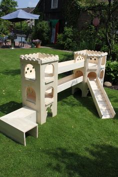 a white wooden bench with stairs and steps in the grass