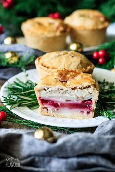 a piece of pie on a plate with holly and gold decorations around it, surrounded by other pastries