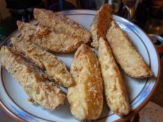 some fried food is on a white and blue plate