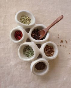 five small bowls with different spices in them