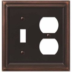 an old - fashioned switch plate with two outlets in the middle and one on the side