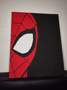 a spiderman face painted on a black and red canvas