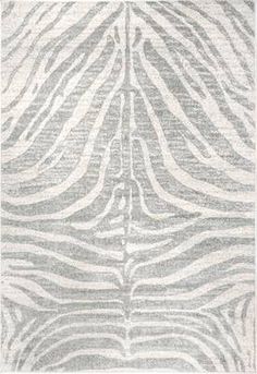 a gray and white rug with zebra stripes