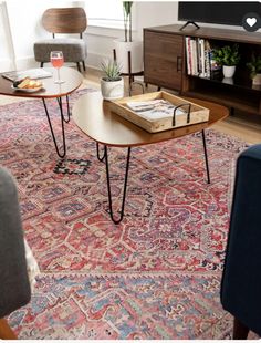 a living room filled with furniture and a large rug