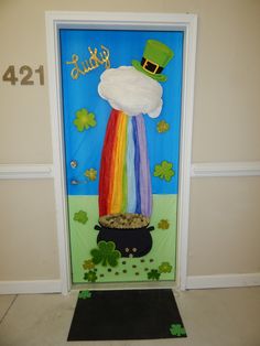 a st patrick's day door decorated with shamrocks and a rainbow