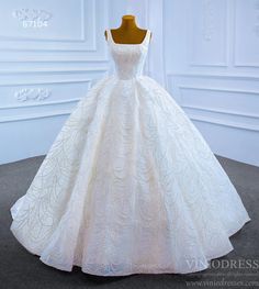 a white wedding dress on display in front of a mannequin's head