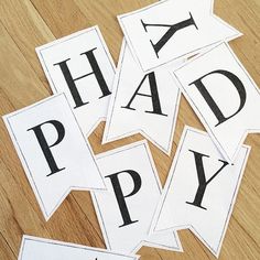 the letters have been cut out to spell happy days on paper and placed on a wooden floor