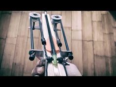 someone is holding their skis and poles in the middle of an overhead shot with wood flooring behind them