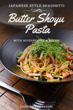 a black plate topped with pasta and vegetables