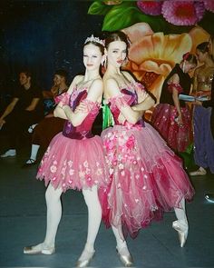 two ballerinas in pink tutu skirts posing for the camera