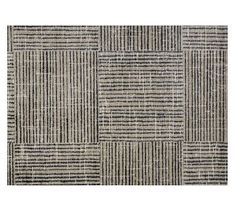 an area rug with black and white stripes on it, in the shape of squares