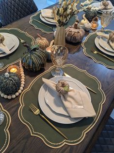 a table set with place settings for thanksgiving dinner