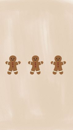 three gingerbread men are standing in the middle of a row on a beige background