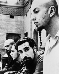 black and white photograph of men with beards looking at something in front of them