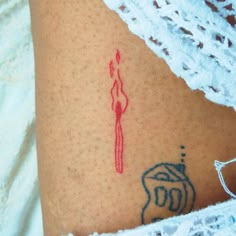 a woman's stomach with a tattoo on it that has a red line in the shape of a female figure