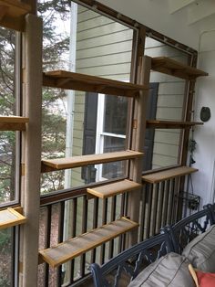 a balcony with wooden shelves and metal railings