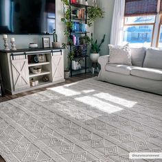 a living room filled with furniture and a flat screen tv