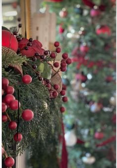 the christmas tree is decorated with red and green ornaments