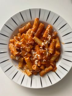 a white bowl filled with pasta covered in sauce