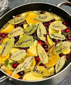 a pot filled with lots of fruit and writing on it