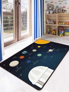 a child's room with a rug that has planets and stars on the floor