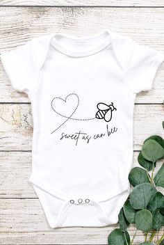 a white baby bodysuit with the words sweet as can be written in black on it