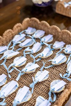 several pieces of paper with blue ribbons are on a table in front of other items