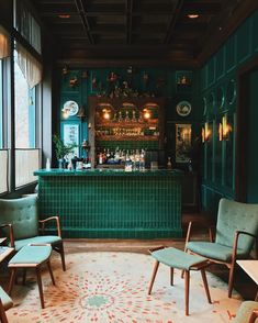 a green tiled bar with chairs and stools