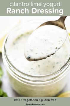 a spoon full of ranch dressing in a jar